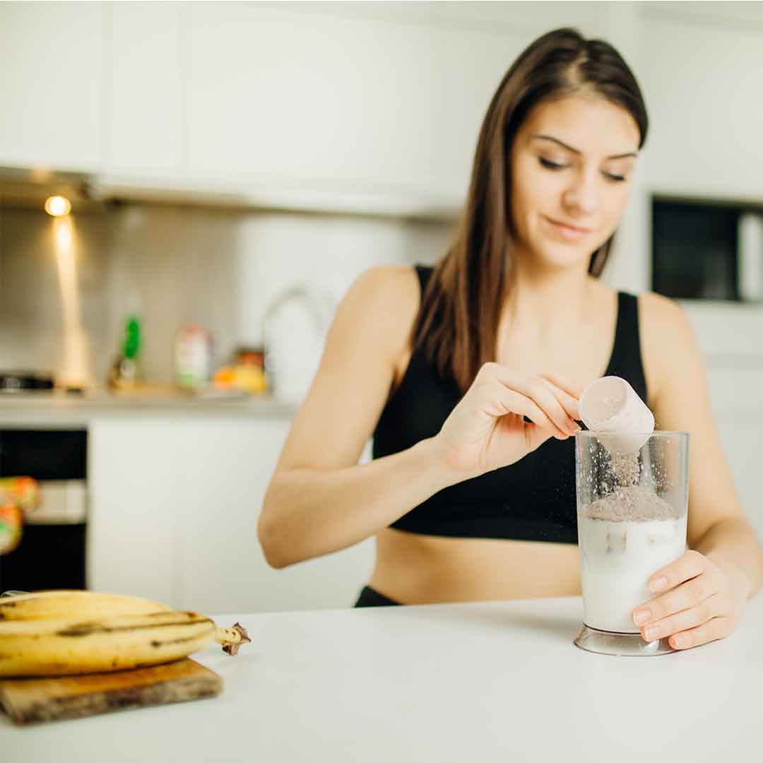 woman making a protein shake