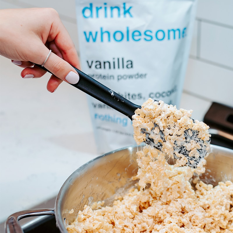 protein-powder-rice-krispie-treats a woman making protein powder rice krispie treats with drink wholesome protein powder