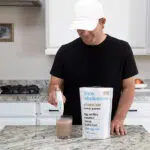a man making a protein shake with a drink wholesome electric mixer